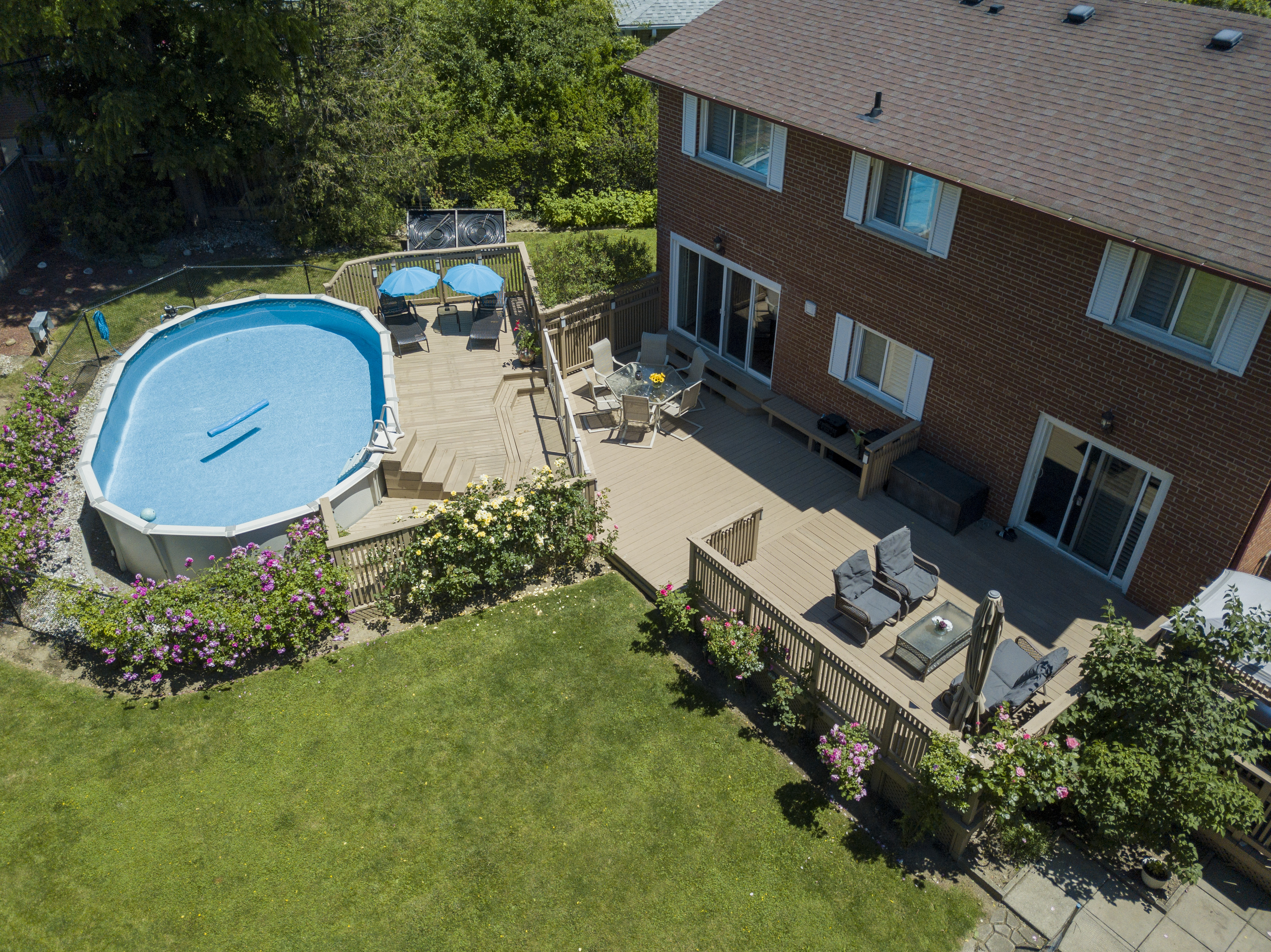 Aerial view of a home with a pool and large deck